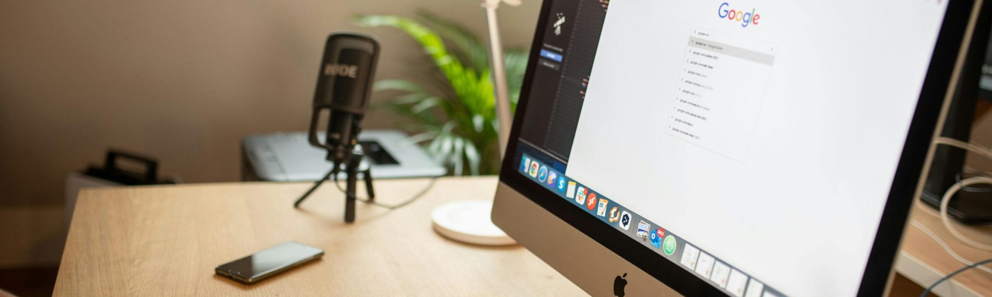 A modern workspace with an iMac displaying Google search, perfect for remote work setups.